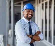 Man in blue hard hat and tie